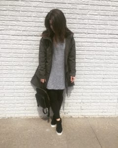 A black and white striped tunic over black leggings with black sneakers. I have a dark green rain coat on top.