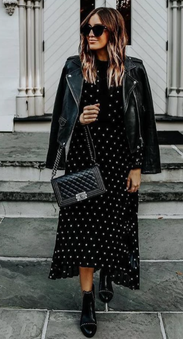 The third Pinterest inspired outfit inspiration. A woman is wearing a long beige cardigan over a white top and white pants. She is wearing black and brown leopard print boots and has a tan cross body bag across her chest.