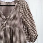 A partial image of a brown and white gingham summer dress that I made for my capsule wardrobe.