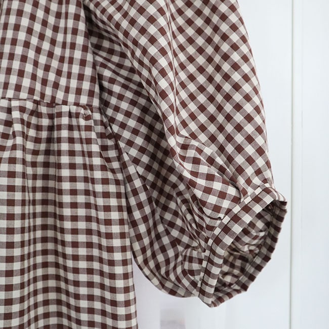 An image of the balloon sleeve of a brown and white gingham summer dress that I made for my capsule wardrobe.
