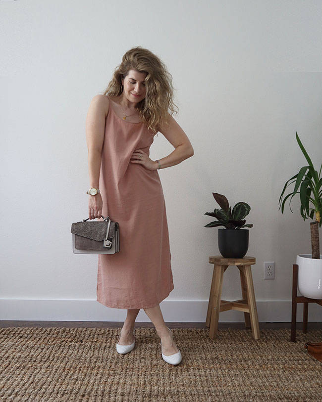 Mini capsule outfit 1 - a pink slip dress with white slingback shoes and a grey purse.