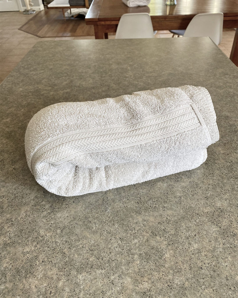 The towel roll was folded in half to squeeze water out.