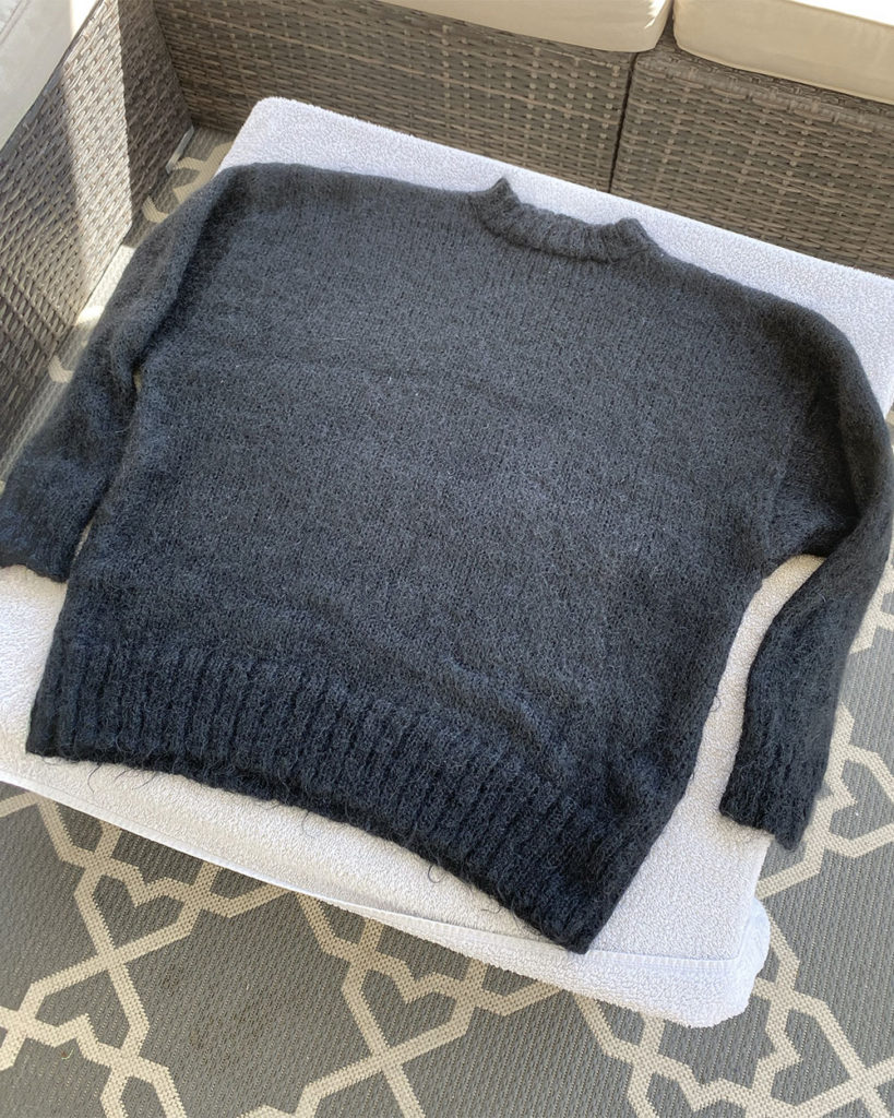 The sweater was laid out flat on a clean, dry towel to dr.y outside