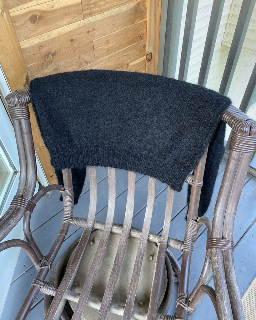 The sweater was hanged over a chair to dry outside overnight to completely dissipate the mothball smell.