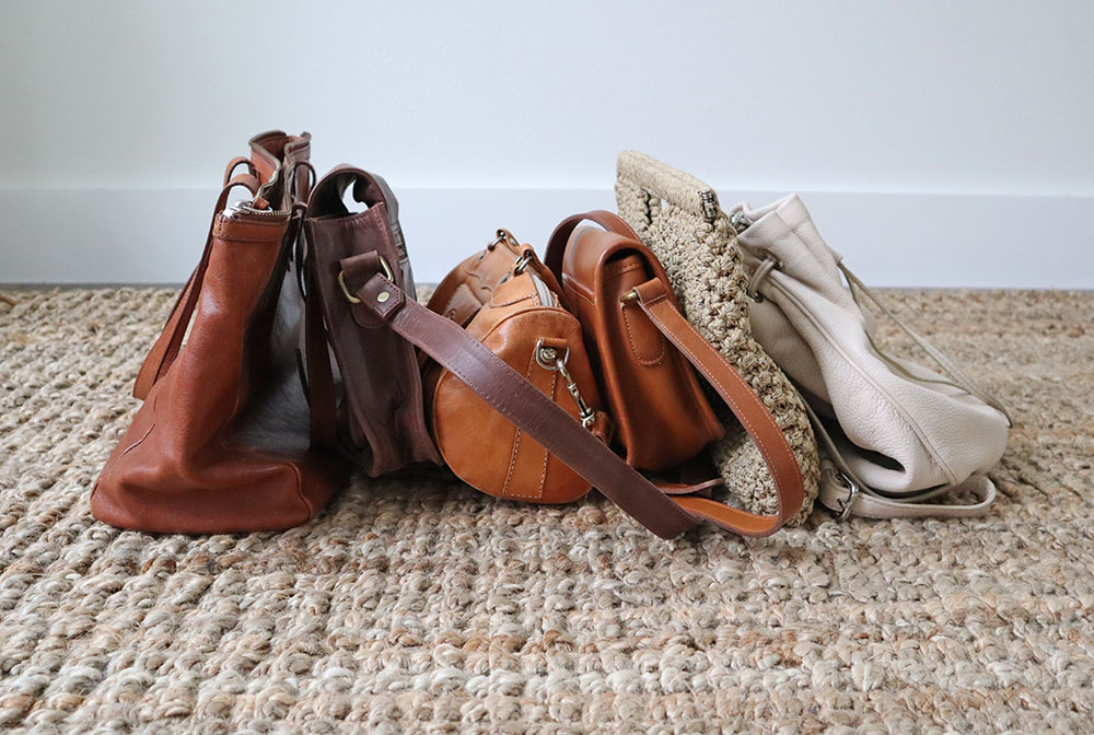 All of my brown, tan and white bags are lined up.