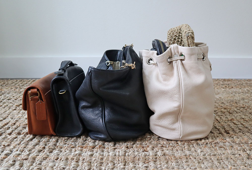 Pile of used worn secondhand bags handbags for sale Stock Photo