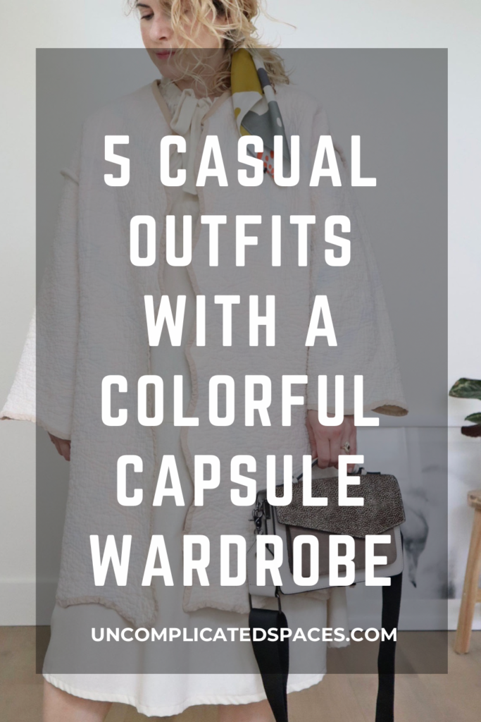 A photo of a white woman with blond wavy hair who is wearing a white coat over a while dress and holding a grey handbag has the text "5 casual outfits with a colorful capsule wardrobe" on top.