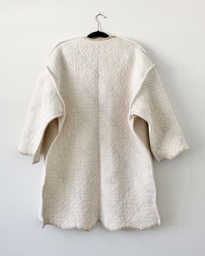 The back of the quilted coat on the cream side.
