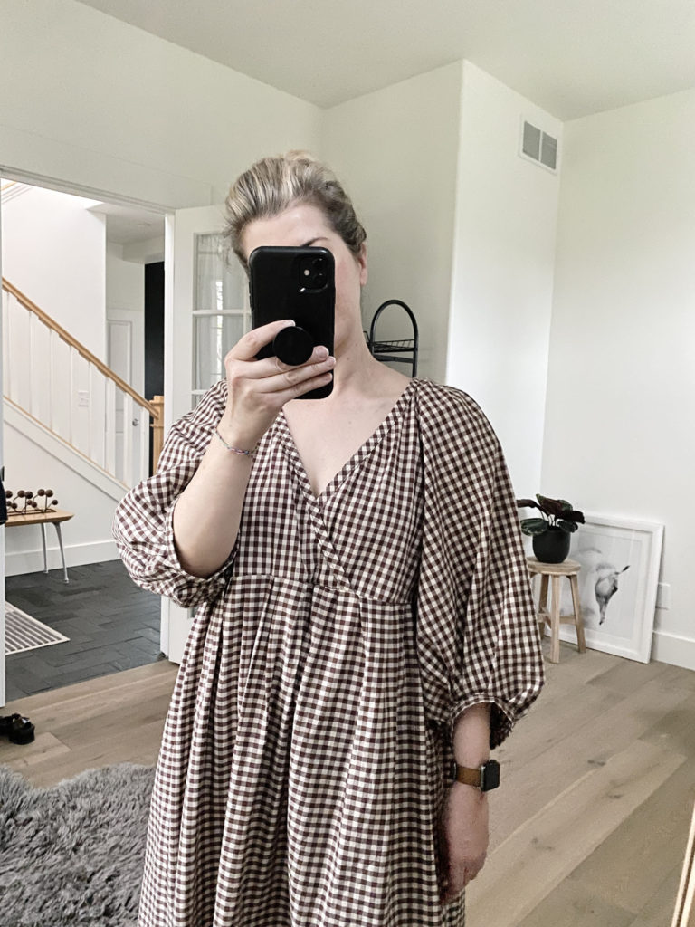 A mirror selfie of the woman showing a closeup go the neckline which is a faux wrap.